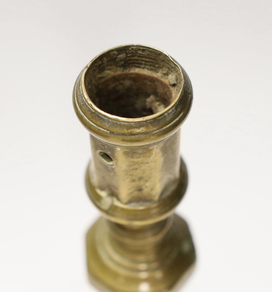 A 17th century continental brass candlestick. 28cm high